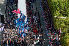 Volunteers walk on a catwalk during a parade down the Avenue des Champs-Elysees for all the French athletes who participated in the 2024 Olympics and Paralympics Games in Paris on Sept. 14, 2024.
