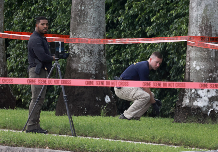 Law enforcement personnel investigate the area around Trump International Golf Club after an apparent assassination attempt of former US President Donald Trump on Sept. 15, 2024 in West Palm Beach, Florida. The FBI and US Secret Service, along with the Palm Beach County Sheriff's office, are investigating the incident, which the FBI said “appears to be an attempted assassination of former President Trump“ while he was golfing at the course.