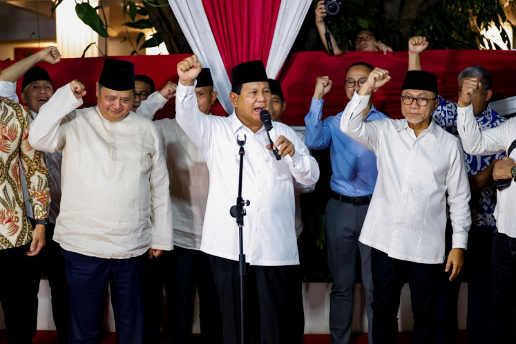 President-elect Prabowo Subianto, along with his coalition members, gestures as he delivers a speech in Jakarta on March 20, 2024, after the General Elections Commission (KPU) announced the 2024 presidential election results.