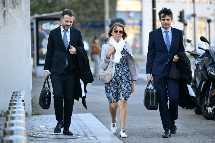 Gisele Pelicot (center) arrives with her lawyers Stephane Babonneau (right) and Antoine Camus at the Avignon courthouse during the trial of her former partner Dominique Pelicot accused of drugging her for nearly ten years and inviting strangers to rape her at their home in Mazan, a small town in the south of France, in Avignon, on September 17, 2024. A court in the southern town of Avignon is trying Dominique Pelicot, a 71-year-old retiree, for repeatedly raping and enlisting dozens of strangers to rape his heavily sedated wife in her own bed over a decade. Fifty other men, aged between 26 and 74, are also on trial for alleged involvement, in a case that has horrified France. The court proceedings, which runs until December, are open to the public at the request of Dominique Pelicot's ex-wife and victim. 