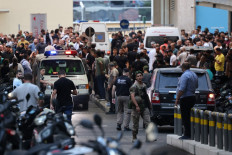 Ambulances are surrounded by people at the entrance of the American University of Beirut Medical Center, on September 17, 2024, after explosions hit locations in several Hezbollah strongholds around Lebanon amid ongoing cross-border tensions between Israel and Hezbollah fighters. Hundreds of people were wounded when Hezbollah members' paging devices exploded simultaneously across Lebanon on September 17, in what a source close to the militant movement said was an “Israeli breach“ of its communications. 