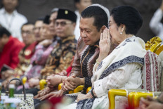 Former president and current Indonesian Democratic Party of Struggle (PDI-P) chairwoman Megawati Soekarnoputri (right) whispers to People's Consultative Assembly (MPR) Speaker Bambang Soesatyo during an event at the Senayan legislative complex in Jakarta on Sept. 9, 2024.