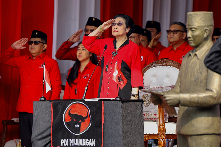 Standing to salute: Indonesian Democratic Party of Struggle (PDI-P) chairwoman Megawati Soekarnoputri (center) and secretary-general Hasto Kristiyanto (left) salute the red-and-white flag during the 79th Independence Day flag ceremony at the party's building in Jakarta on Aug. 17.