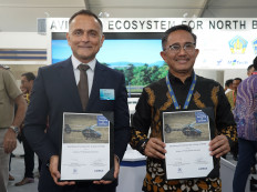 Airbus Helicopters business and development director Régis Antomarchi (left) and PT Dirgantara Indonesia commercial, technology and development director M. Arif Faisal pose with signed documents on the sidelines of the Bali International Airshow in Badung, Bali, on Sept. 18, 2024. The agreement covers the procurement of four H145 light helicopters for the Indonesian Air Force training program.