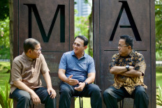 Former Jakarta governor Basuki Tjahaja Purnama, also known as Ahok (center), talks to former cabinet secretary to president Joko Widodo, Pramono Anung (left), and former deputy governor of Banten province, Rano Karno, during a media opportunity in Jakarta on Sept. 19, 2024. Pramono and Karno are running for governor and deputy governor of the capital in the upcoming regional election. 
