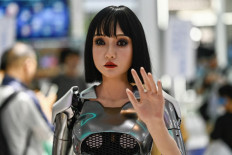A humanoid robot gestures while on display during the World Intelligence Expo in Tianjin, China, on June 23, 2024.