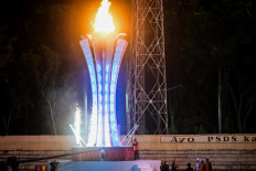Retired North Sumatran boxer Samsul Anwar lights the flame for the 21st National Games (PON) at Baharoeddin Siregar Stadium in Deli Serdang regency, North Sumatra, during the event’s opening ceremony on Sept. 9, 2024. Aceh and North Sumatra jointly hosted the 2024 installment of the national multisports event, which featured nearly 13,000 athletes.