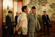 Philippine President Ferdinand Marcos Jr (left) walks with Defense Minister and president-elect Prabowo Subianto during the latter's visit to the Malacanang Palace in Manila on Sept. 20, 2024.