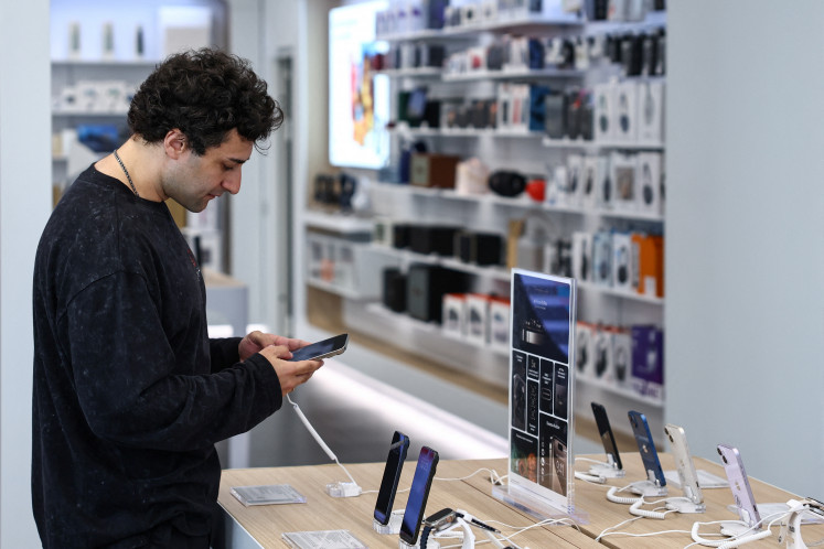 A man holds an Apple iPhone 16 Pro Max ahead of the launch of sales of the new iPhone 16 series smartphones in a store in Moscow on Sept. 20, 2024.