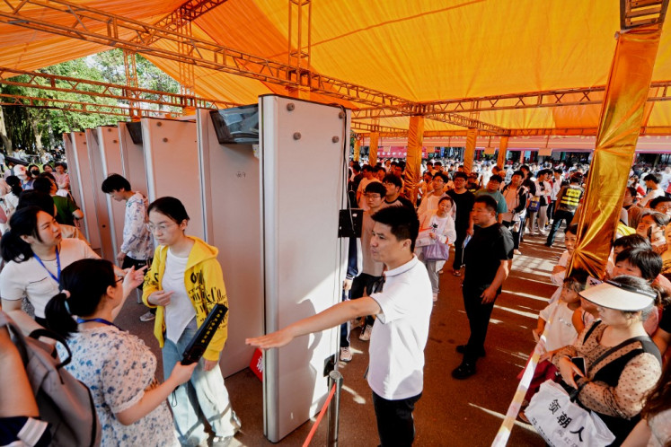 Students line up to pass a security check outside a school on the first day of the national college entrance examination, known as “Gaokao“, in Bozhou, in central China's Anhui province on June 7, 2024.