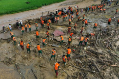 Rescue officials sift through debris at the site of a landslide in the remote mountainous village of Lang Nu, in Lao Cai province on Sept. 12, 2024, in the aftermath of Typhoon Yagi hitting northern Vietnam.