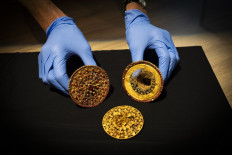 An employee shows a pair of ‘subeng’ (ear studs) from Bali’s Tabanan Kingdom on Sept. 20, 2024 at the Wereldmuseum Amsterdam in the Dutch capital. The Netherlands’ Education, Culture and Science Ministry has announced the country is returning 288 artifacts taken from Indonesia during the Dutch colonial era.