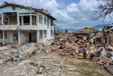 People clean up the debris of destroyed and damaged buildings in the aftermath of bombardments carried out by Myanmar's military in Lashio in Myanmar's northern Shan State on September 24, 2024. Lashio is the largest urban center to fall to any of Myanmar's myriad ethnic minority armed groups who have been fighting the central authorities on and off for decades, but analysts say the Myanmar National Democratic Alliance Army (MNDAA) will struggle to govern the strategic city.