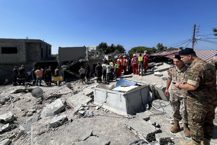 People inspect the damage at the site of an Israeli strike on the Mount Lebanon village of Maaysra, east of the Christian coastal town of Byblos, on Sept. 25, 2024. Lebanon said 15 people were killed in Israeli strikes on the same day, including two rare strikes in mountain areas outside Hezbollah's traditional strongholds in the south and east.