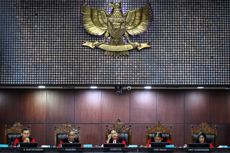 Constitutional Court Chief Justice Suhartoyo (center) presides over a hearing on a judicial review petition regarding the age requirement for candidates of Corruption Eradication Commission (KPK) leaders at the court's building in Jakarta on Sept. 12.