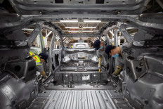 Employees work on an electric vehicle (EV) production line at a Volkswagen Anhui factory in Hefei, Anhui province, China, on Sept. 25, 2024.