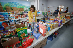 A resident gathers supplies from a voluntary community-run relief center in the aftermath of Hurricane Helene in Cruso, North Carolina, the United States, on Oct. 3, 2024.