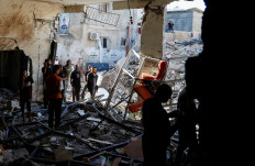 Palestinians inspect the damage at the site of an Israeli air strike in Tulkarm camp in Tulkarm in the Israeli-occupied West Bank on Oct. 4, 2024.