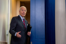 United States President Joe Biden turns around to joke with a reporter as he leaves a news conference in the Brady Press Briefing Room at the White House in Washington, DC on Oct. 4, 2024. Biden made a surprise appearance, his first in the briefing room since becoming president, to tout a positive job report and take questions from reporters.