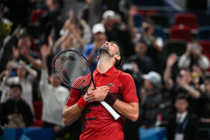 Serbia's Novak Djokovic celebrates after winning against USA's Alex Michelsen during their men's singles match at the Shanghai Masters tennis tournament in Shanghai, China on Oct. 5, 2024.