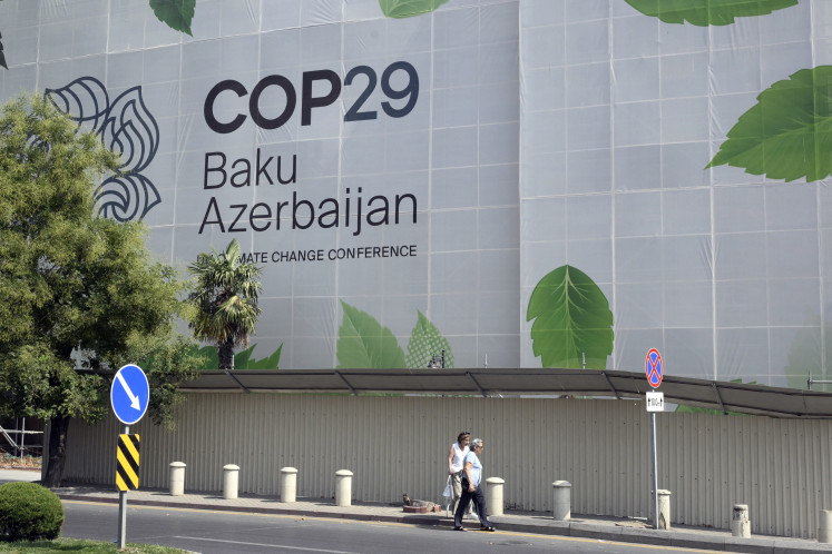 Branding for the COP29 climate conference covers the facade of a building under renovation in the Azerbaijani capital of Baku on September 11, 2024. The 2024 UN Climate Change Conference (UNFCCC COP 29) will convene from Nov. 11 to 22 in Baku.