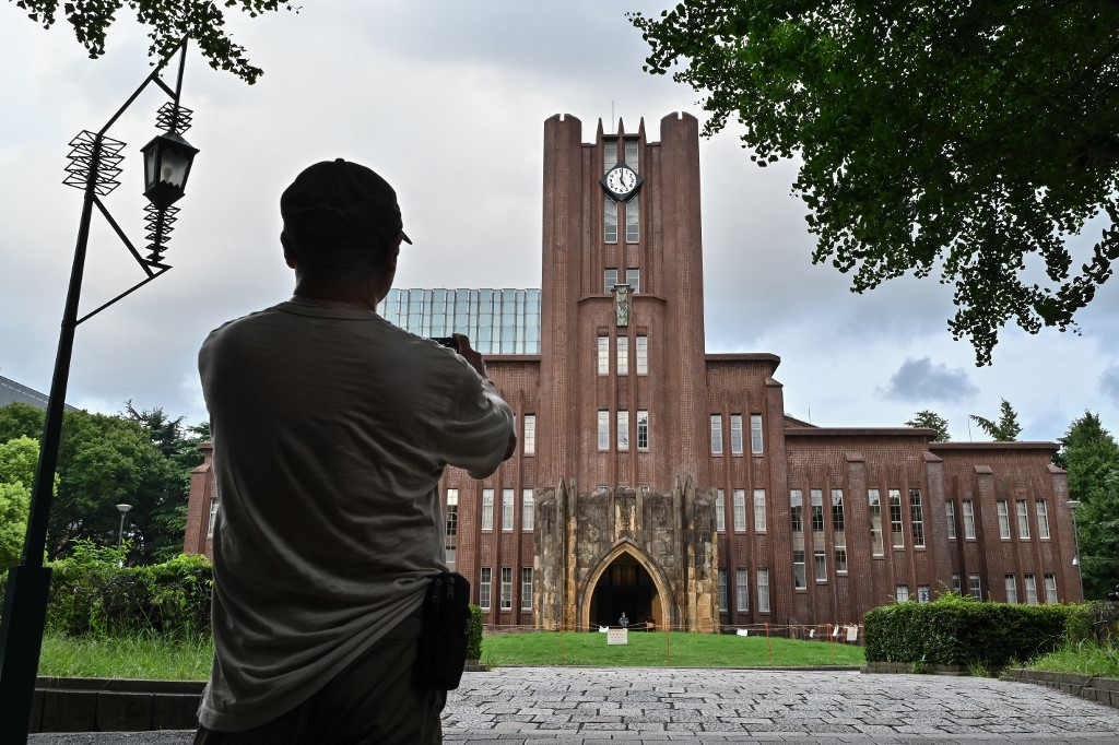 A man takes a photo of Yasuda Auditorium, built in 1925, at the University of Tokyo, also known as Todai, in Tokyo on Aug. 22, 2024. Just one in 10 researchers at the prestigious University of Tokyo are women, and one in five students.