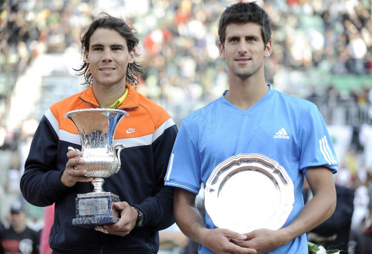 Rafael Nadal of Spain (left) and Novak Djokovic of Serbia pose with their trophies after their final match of the ATP Tennis Open match in Rome on May 3, 2009 after Nadal won the tournament 7-6, 6-2. Rafael Nadal announced on Oct. 10, 2024 he will retire from professional tennis after the Davis Cup finals in November, ending a career in which he won 22 Grand Slam titles and Olympic singles gold.