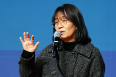 This undated photo released by Yonhap news agency on October 10, 2024 shows South Korean author Han Kang delivering a speech at a lecture in Gwangju. 