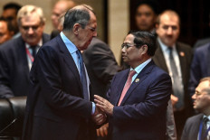 Russias Foreign Minister Sergei Lavrov (left) shakes hands with Vietnam's Prime Minister Pham Minh Chinh (right) at the 19th East Asia Summit during the 44th and 45th Association of Southeast Asian Nations (ASEAN) Summits in Vientiane on October 11, 2024.