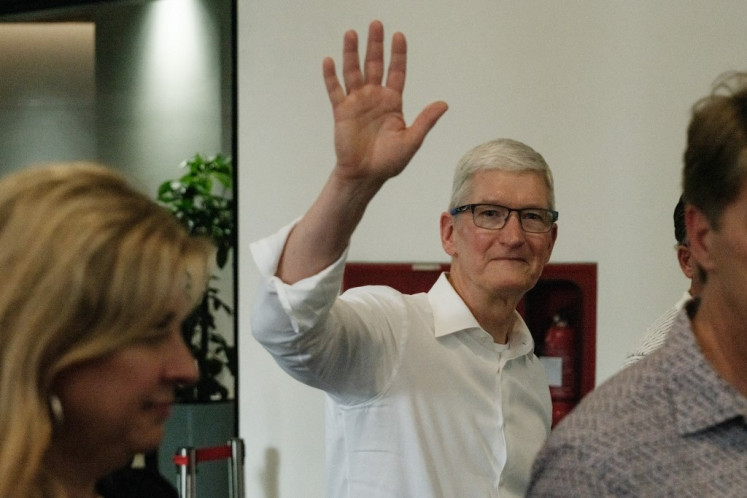 Apple CEO Tim Cook reacts as he leaves the Apple Developers Academy during his visit to Indonesia in Tangerang, Banten,  on April 17, 2024.