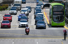 Vehicles drive at an intersection in the Chinatown district of Singapore on Oct. 7, 2024.