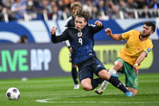 Japan's Ayase Ueda (left) and Australia's Patrick Yazbek compete for the ball during the FIFA World Cup 2026 Asian zone qualifiers football between Japan and Australia at Saitama Stadium in Saitama on October 15, 2024. 