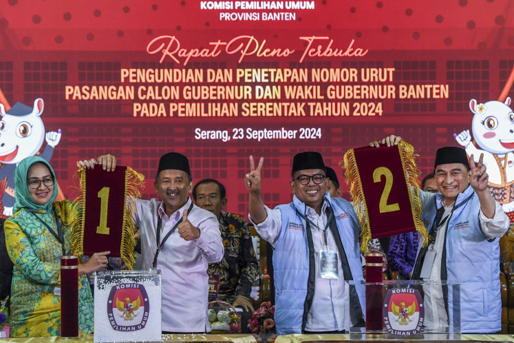 Banten gubernatorial candidate pairs (from left to right) Airin Rachmi Diany and Ade Sumardi and Andra Soni and Achmad Dimyati Natakusumah pose with their ballot numbers on Sept. 23, 2024, at an event at the Banten General Elections Commission (KPU) in Serang, Banten.