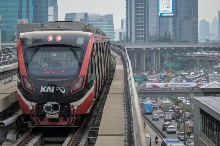 A Greater Jakarta light rail transit (LRT) train passes above Jl. Gatot Soebroto in Jakarta on Oct. 4, 2024.