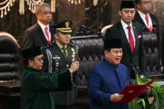 President Prabowo Subianto (right) takes the oath during the presidential inauguration ceremony on Oct. 20, 2024, at the House of Representatives building in the Senayan Legislative Complex in Central Jakarta.