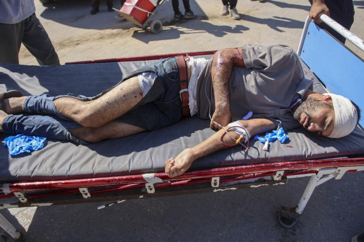 A man who was injured during an Israeli operation in the Jabalia refugee camp in the central Gaza Strip lies on a bed at Al-Ahli Arab hospital, also known as the Baptist hospital in Gaza City on October 21, 2024, amid the ongoing war in the Palestinian territory between Israel and Hamas. 