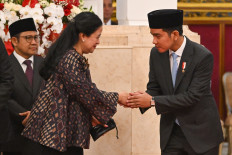 Vice President Gibran Rakabuming Raka (right) greets House of Representatives Speaker Puan Maharani (center) of the Indonesian Democratic Party of Struggle (PDI-P) on Oct. 22, 2024 at the State Palace in Jakarta as Coordinating Social Empowerment Minister Muhaimin Iskandar looks on, prior to a ceremony to install presidential envoys and aides, as well as the new heads of state institutions.