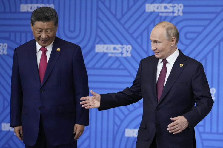 Chinese President Xi Jinping and Russian President Vladimir Putin are seen on Oct. 23, 2024, during the BRICS summit in Kazan, Russia. 