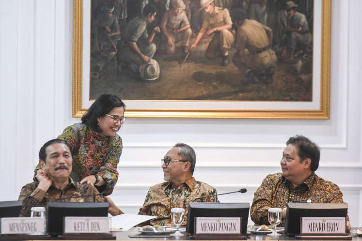 Coordinating Economic Minister Airlangga Hartarto (right) talks with Coordinating Food Minister Zulkifli Hasan (second right), Finance Minister Sri Mulyani Indrawati (second left) and National Economic Council chair Luhut Binsar Pandjaitan (left) ahead of President Prabowo Subianto's administration first plenary cabinet meeting at the Presidential Office in Jakarta on Oct. 23, 2024.