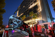 Syrian emergency and security services inspect the wreckage of a car that exploded in Damascus on October 21, 2024. Syria's defense ministry said two civilians were killed in an Israeli strike on a vehicle on October 21 afternoon in the Mazzeh district of Damascus, home to embassies and security headquarters. 