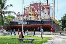 People visit the PLTD Apung 1, a 2004 Indian Ocean tsunami landmark on the weekend of the Idul Fitri holiday, marking the end of the Muslim holy fasting month of Ramadan, in Banda Aceh, Aceh on April 14, 2024.