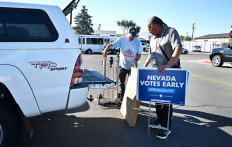 Little Buck Harjo carries 'Nevada Votes Early' signs at the reno-Sparks Indian Colony in Reno, Nevada on Oct. 15, 2024. A century after they were first recognized as United States citizens, many native Americans that AFP spoke to said they felt cut off from the political process. Neither candidate is talking about Native American issues, and neither has visited a reservation, an own goal in a place like Nevada where the population of indigenous Americans dwarfs Joe Biden's 33,500 winning margin in the state in 2020. And in the absence of a visit, the same frustrations that grip the rest of America are bubbling up.