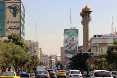 Commuters drive along a street in Tehran on October 26, 2024. Residents of Tehran awoke and went about their business as planned on October 26 after their sleep was troubled by Israeli strikes that triggered blasts that echoed across the city. 