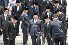 Red and White: The ministers of President Prabowo Subianto's cabinet gather for a group photo after their swearing-in ceremony at the Presidential Palace in Jakarta on Oct. 21. Prabowo's new cabinet includes key members of his predecessor's team and suggests he will continue his main policies, analysts have said. 