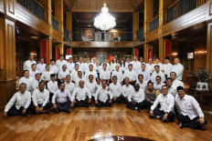 President-elect Prabowo Subianto (sitting, center left) and vice president-elect Gibran Rakabuming Raka (sitting, center right) pose with cabinet minister candidates during a briefing at Prabowo’s residence in Hambalang, Bogor regency, West Java, on Oct. 16. 