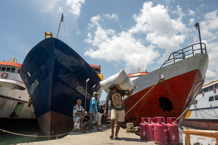 A worker carries a sack filled with agricultural products at Luwuk Port in Banggai regency, Central Sulawesi, on Oct. 29, 2024. Over 250 dock workers, part of the Loading and Unloading Labor Cooperative (TKBM), aid in the transportation of goods and passengers to and from the Banggai Bersaudara region, which includes Banggai, Banggai Islands and Banggai Laut.