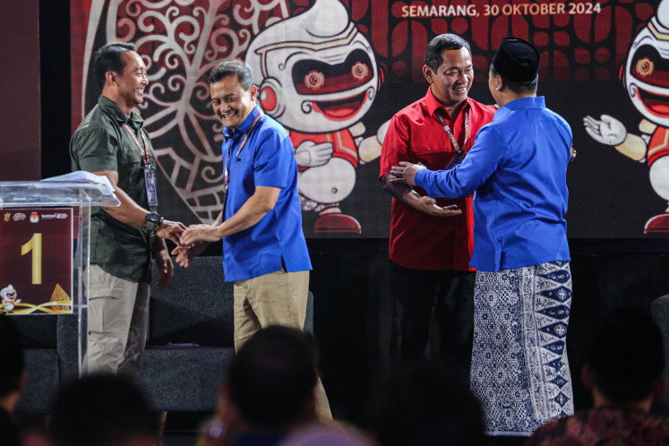 Amicable foes: Central Java gubernatorial candidate Andika Perkasa (left) shakes hands with rival Ahmad Luthfi (second left) while their respective running mates Hendrar Prihadi (second right) and Taj Yasin (right) follow suit after their first public debate at the Marina Convention Center, Semarang, Central Java, on Wednesday. 