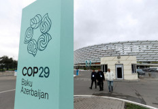 People walk near the Baku Olympic Stadium, the venue of the United Nations Climate Change Conference, or COP29 in Baku, Azerbaijan on Oct. 18, 2024.