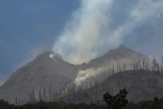 Smoke billows from Mount Lewotobi Laki-Laki as seen from Klatanlo village, in East Flores Regency, East Nusa Tenggara, on November 4, 2024, after it erupted overnight. 