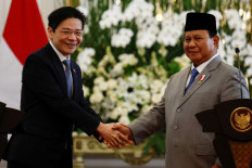 President Prabowo Subianto (right) welcomes Singapore's Prime Minister Lawrence Wong to the State Palace in Jakarta on No. 6, 2024. 